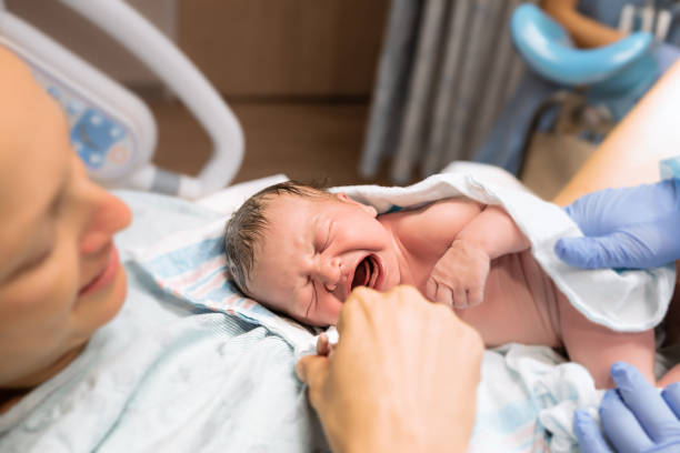 New Mom Holds Her Newborn Baby Girl In The Hospital.