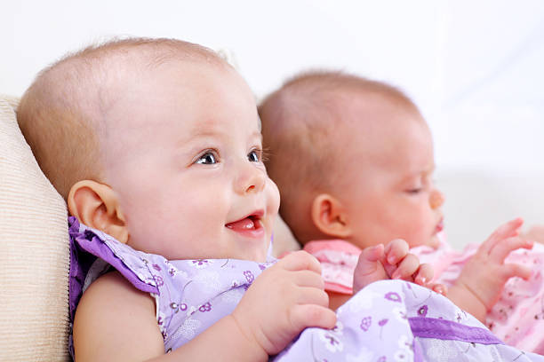 Two Baby Girl Enjoying In Childhood. White Background.